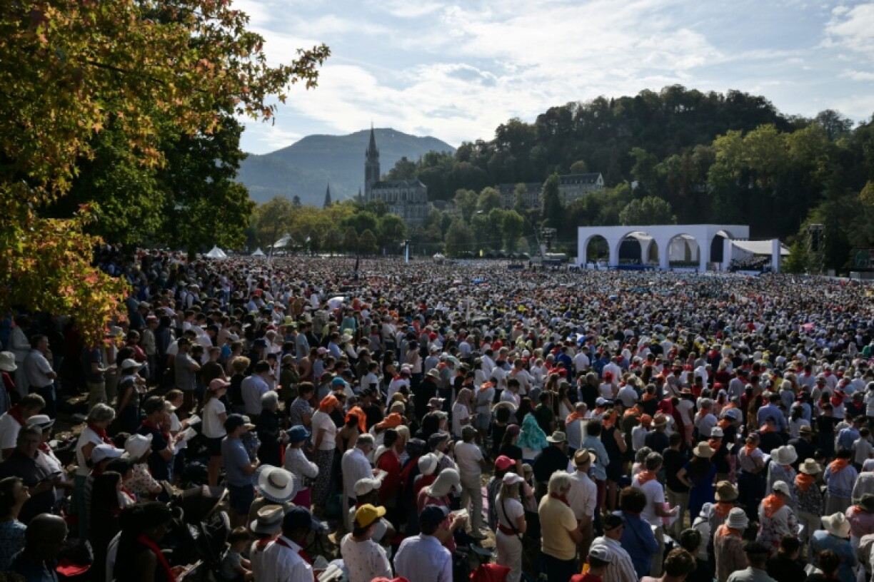 Worshippers packed a field in Lourdes