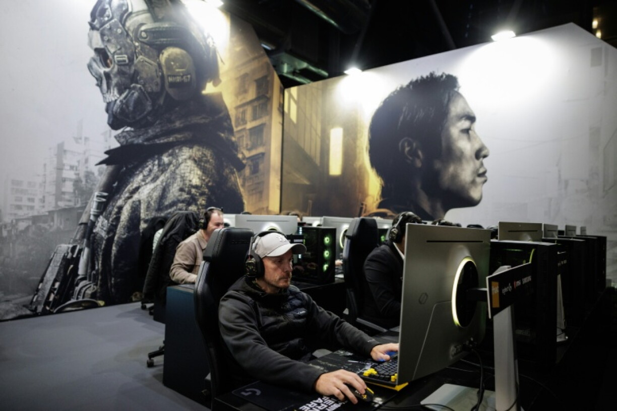 Visitors play 'Call Of Duty Modern Warfare 4' at a Paris preview last week. The game envisions a North Korean invasion of its southern neighbour