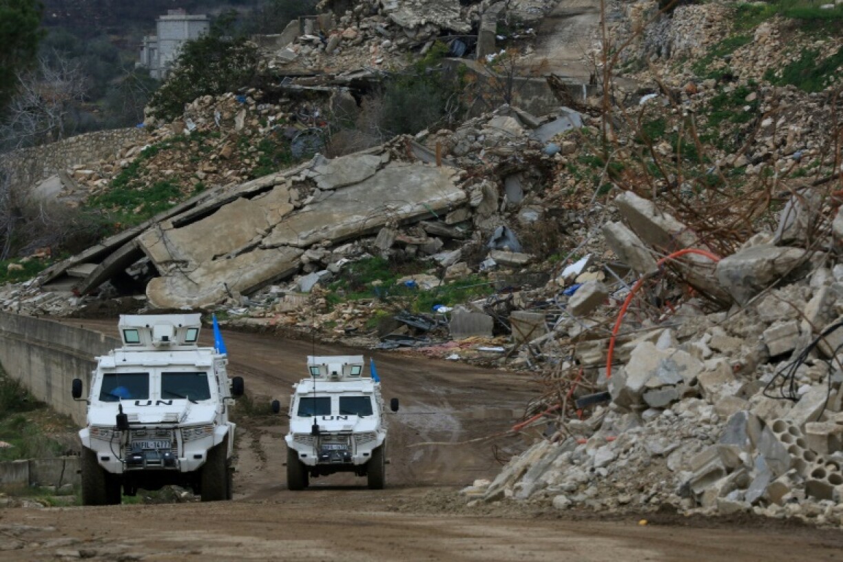 United Nations peacekeepers drive past the rubble of buildings in the southern Lebanese village of Yarine during the ceasefire between Israel and Hezbollah