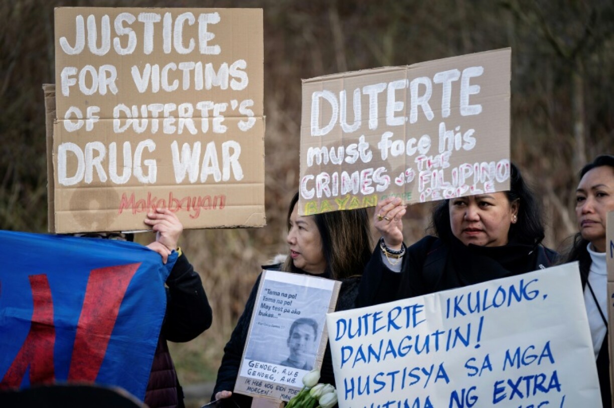 Women protest against Philippines' former president Rodrigo Duterte outside the International Criminal Court in The Hague