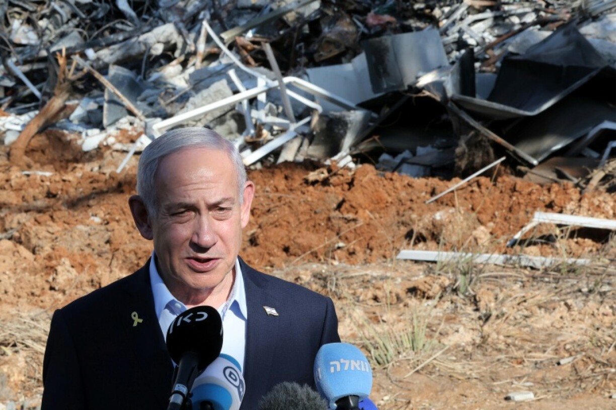 Israel's Prime Minister Benjamin Netanyahu at the site of a missile strike near Tel Aviv