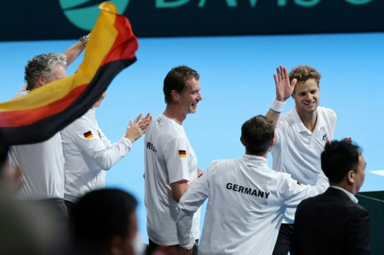 Germany's Yannick Hanfmann (top R) celebrates with teammates after his victory over Japan's Shintaro Mochizuki in Davis Cup second round qualifiers
