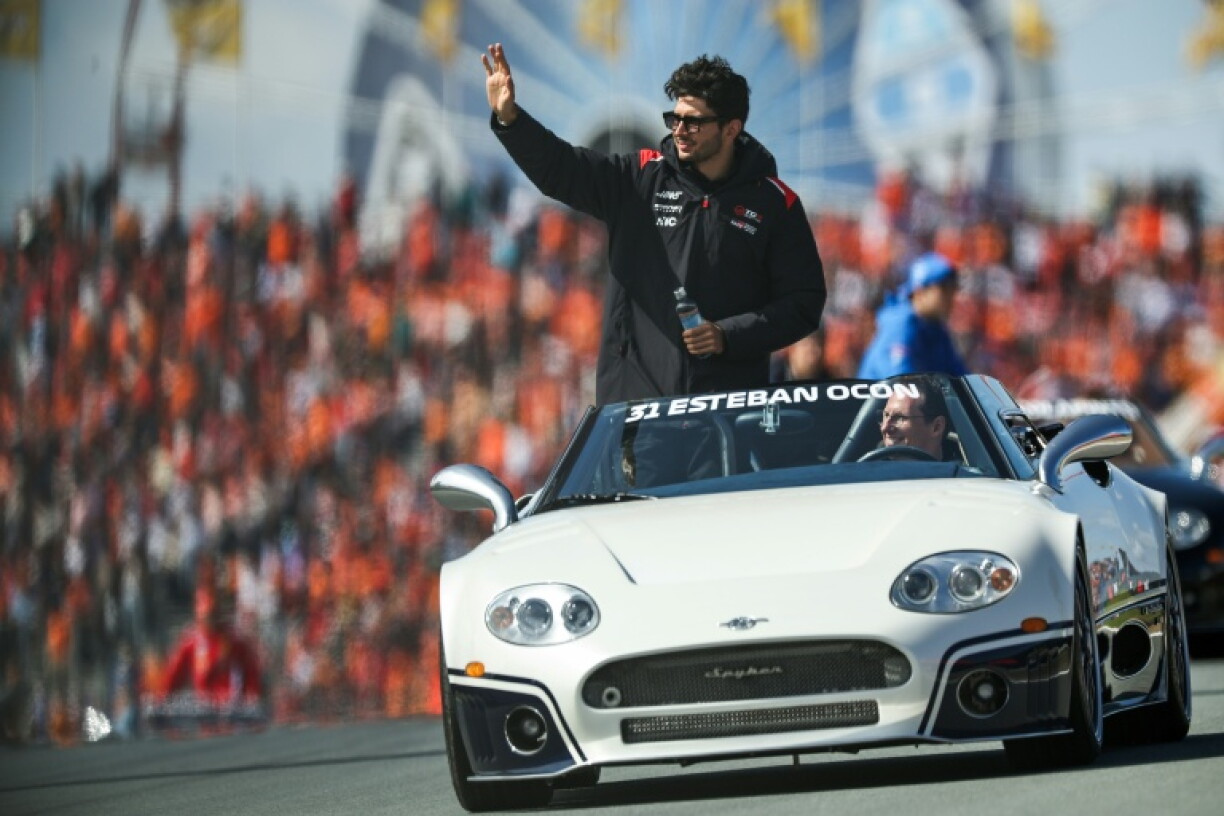Haas F1 Team's French driver Esteban Ocon waves during the drivers parade ahead of the Formula One Dutch Grand Prix at The Circuit Zandvoort, western Netherlands, on August 23, 2026.