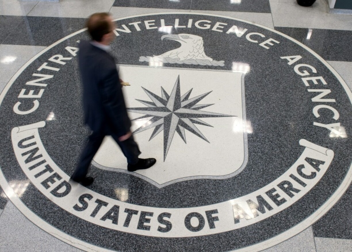 A man crosses the Central Intelligence Agency (CIA) seal in the lobby of CIA Headquarters in Langley, Virginia in August 2008