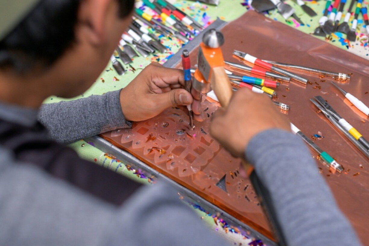 An employee works on the making of traditional 'papel picado' banners at a workshop in San Salvador Huixcolotla, the town where the art form was born over a century ago