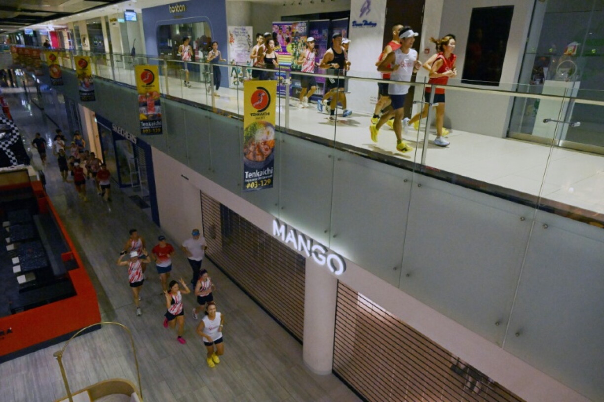 Fitness enthusiasts run inside a Singapore mall