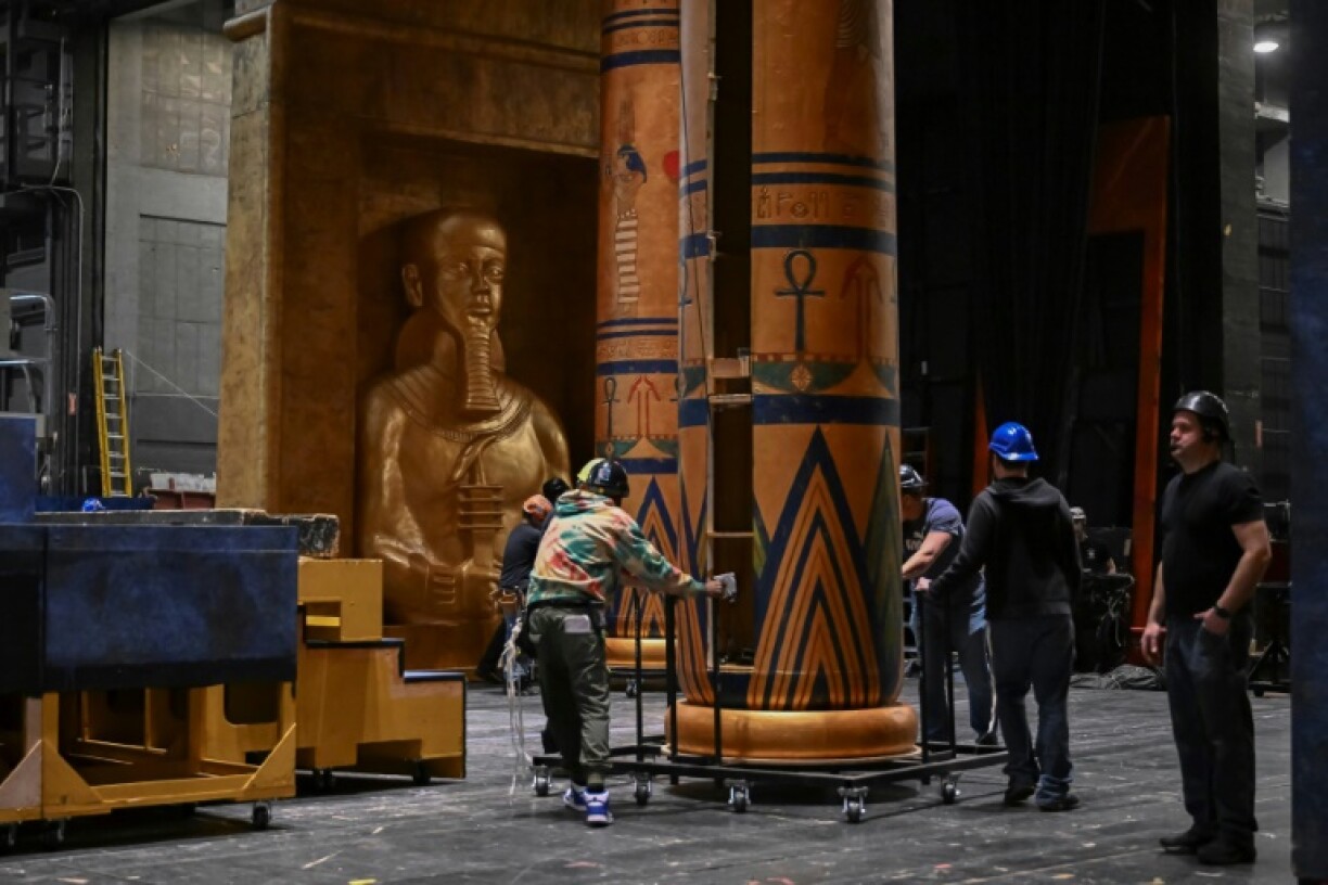 Stage hands move set pieces backstage for Giuseppe Verdi's