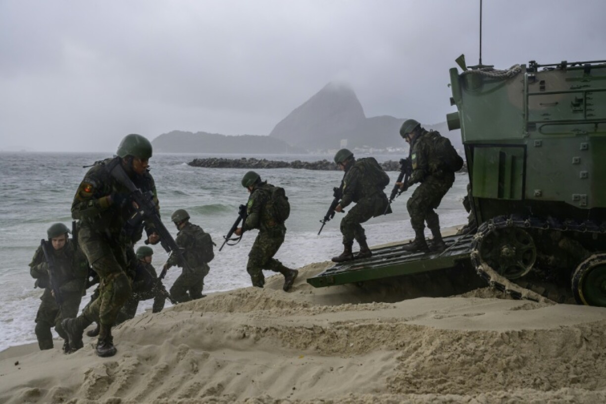 Members of the Brazilian Navy participate in an exercise at Prainha da Gloria beach near the Modern Art Museum (MAM) where the BRICS summit will be held in Rio