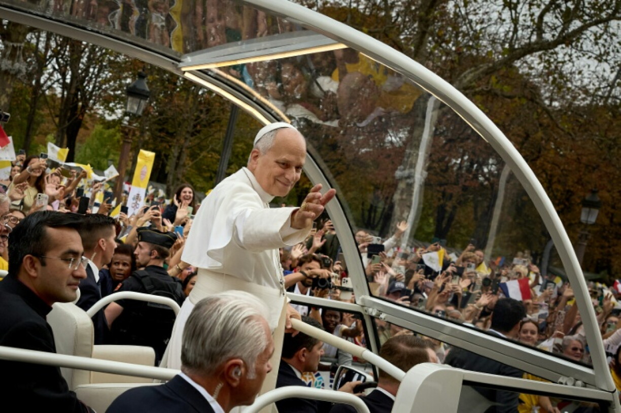 Pope Leo XIV waved to the faithful on his way down the Champs Elysees
