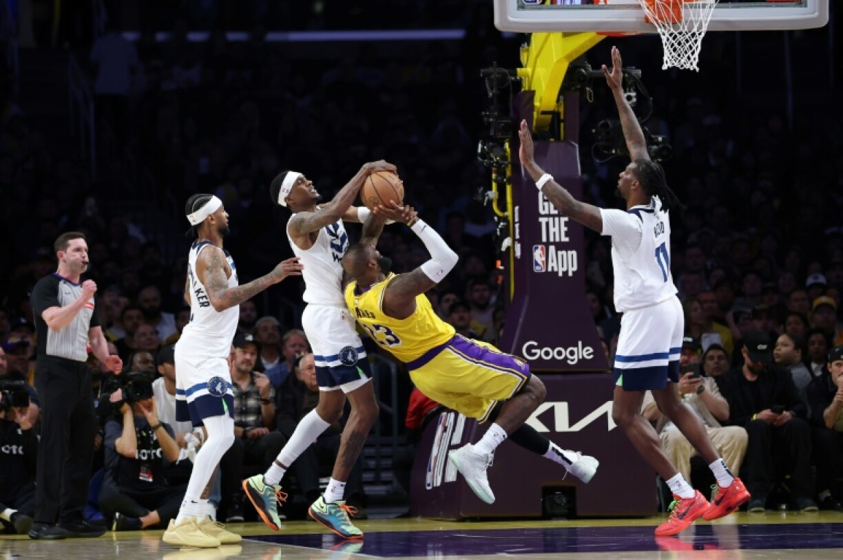 LeBron James of the Los Angeles Lakers attempts a shot while being guarded by Jaden McDaniels in the Lakers' victory over the Minnesota Timberwolves in game two of their NBA playoff series