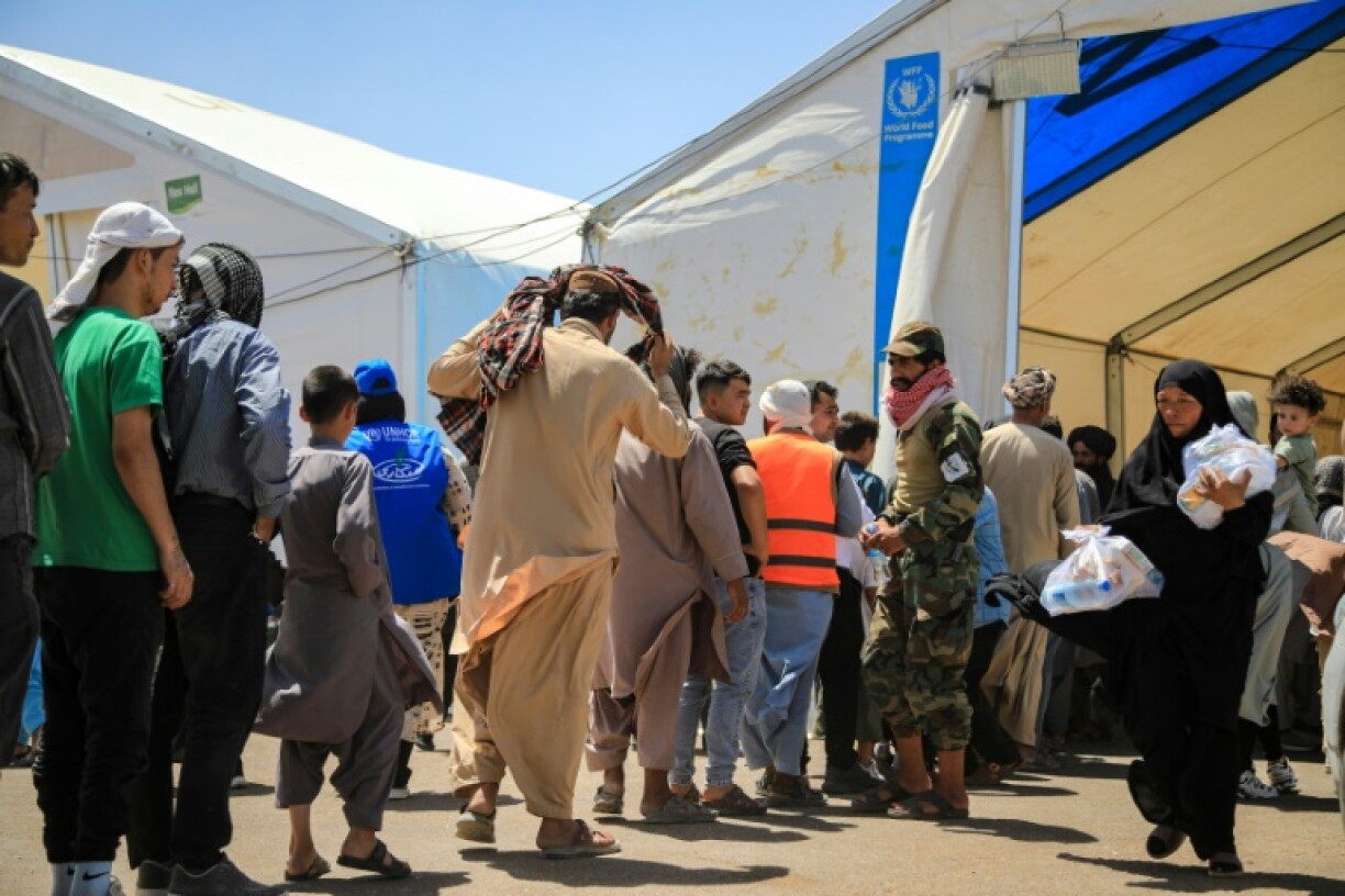 Newly arrived Afghan migrants from Iran queue to receive food packages at the Islam Qala border crossing in Herat. A massive spike in millions of migrants could fuel Islamic State militancy, diplomatic and security sources fear