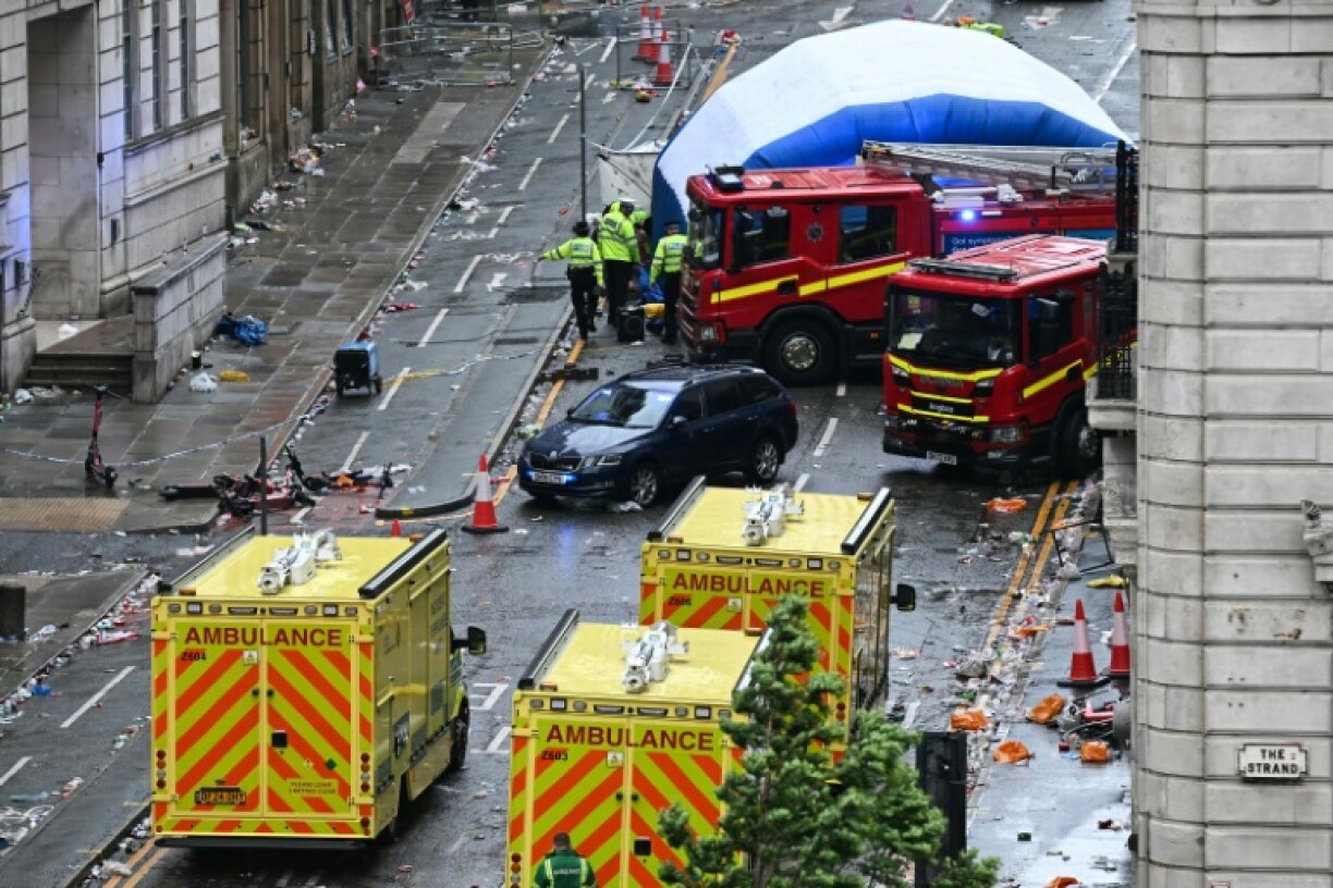 Emergency services in Liverpool's Water Street after a car rammed through football fans celebrating Liverpool's Premier League title win