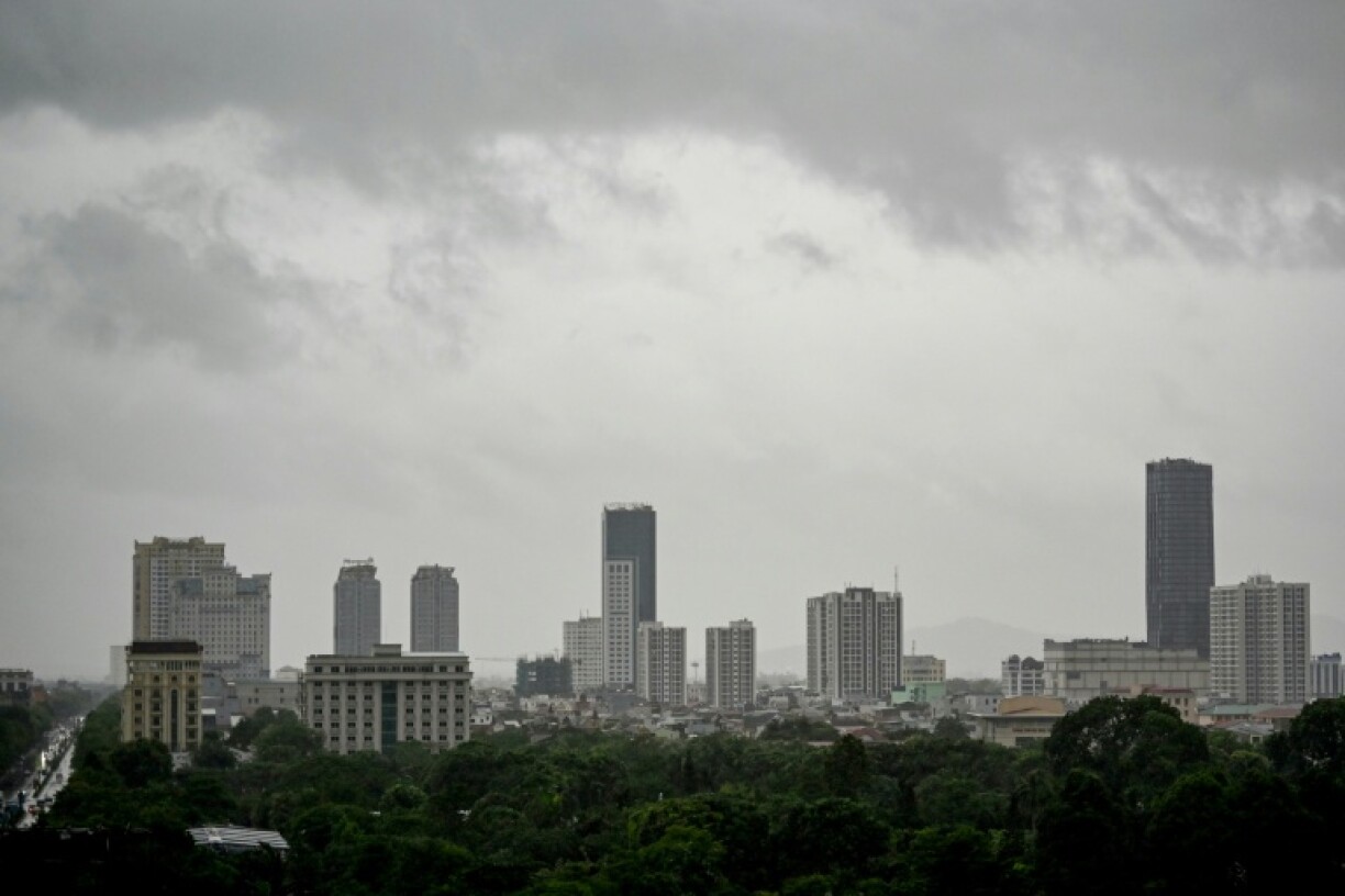 Storm clouds form above the buildings in Vinh city on August 25, 2025, before Typhoon Kajiki makes landfall in Vietnam