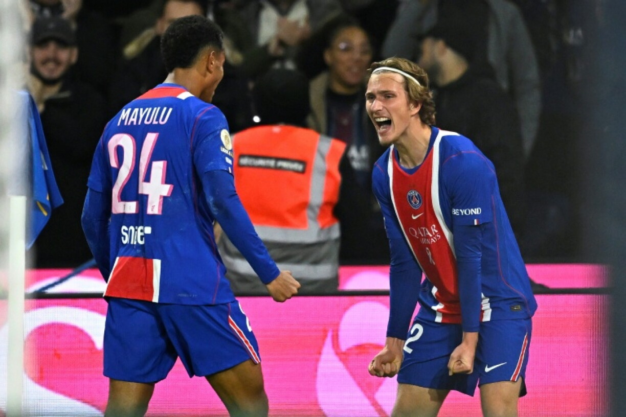 Mika Godts (R) and Senny Mayulu (L) scored the goals as PSG beat Lyon 2-0 on Monday to go top of Ligue 1