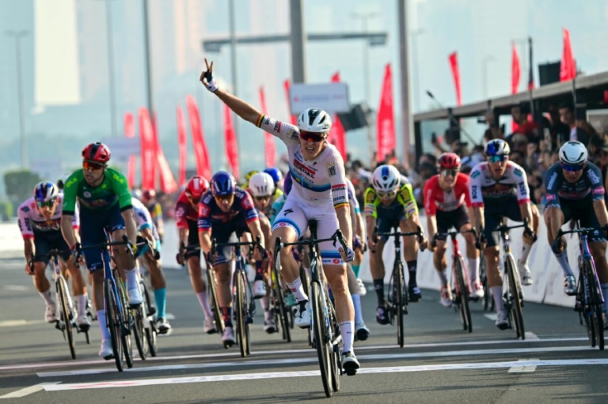 Tim Merlier (C) celebrates a second victory in the UAE Tour