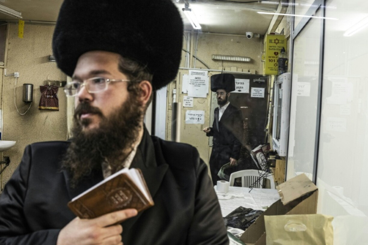 Ultra-Orthodox Jewish men pray in a synagogue in Arad on October 1, 2026. As Israelis prepare to vote in parliamentary elections on October 27, tensions in Arad have become a microcosm of a broader national debate.