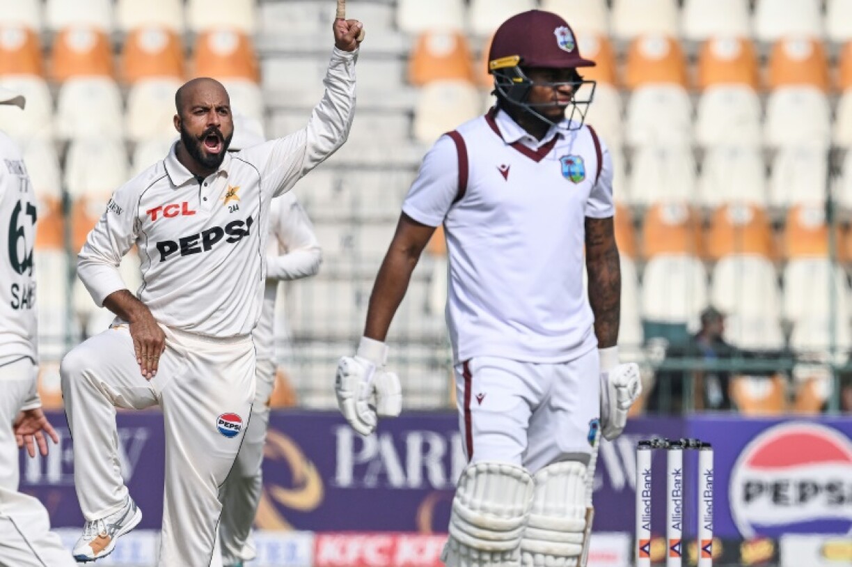Pakistan's Sajid Khan celebrates after taking the wicket of West Indies' Keacy Carty (R) during the second day of the first Test at Multan