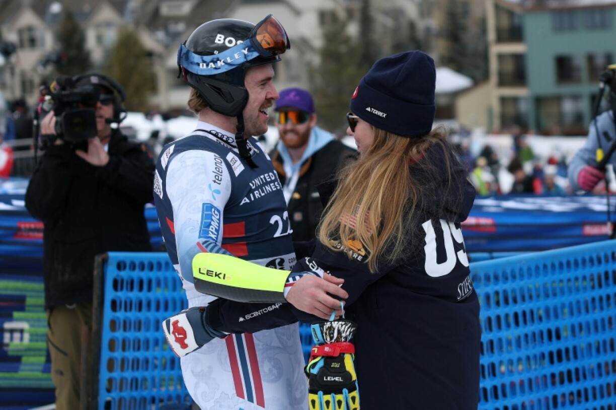 Norway's Aleksander Aamodt Kilde gets a hug from US ski star fiancee Mikaela Shiffrin after his World Cup super-G run at Copper Mountain