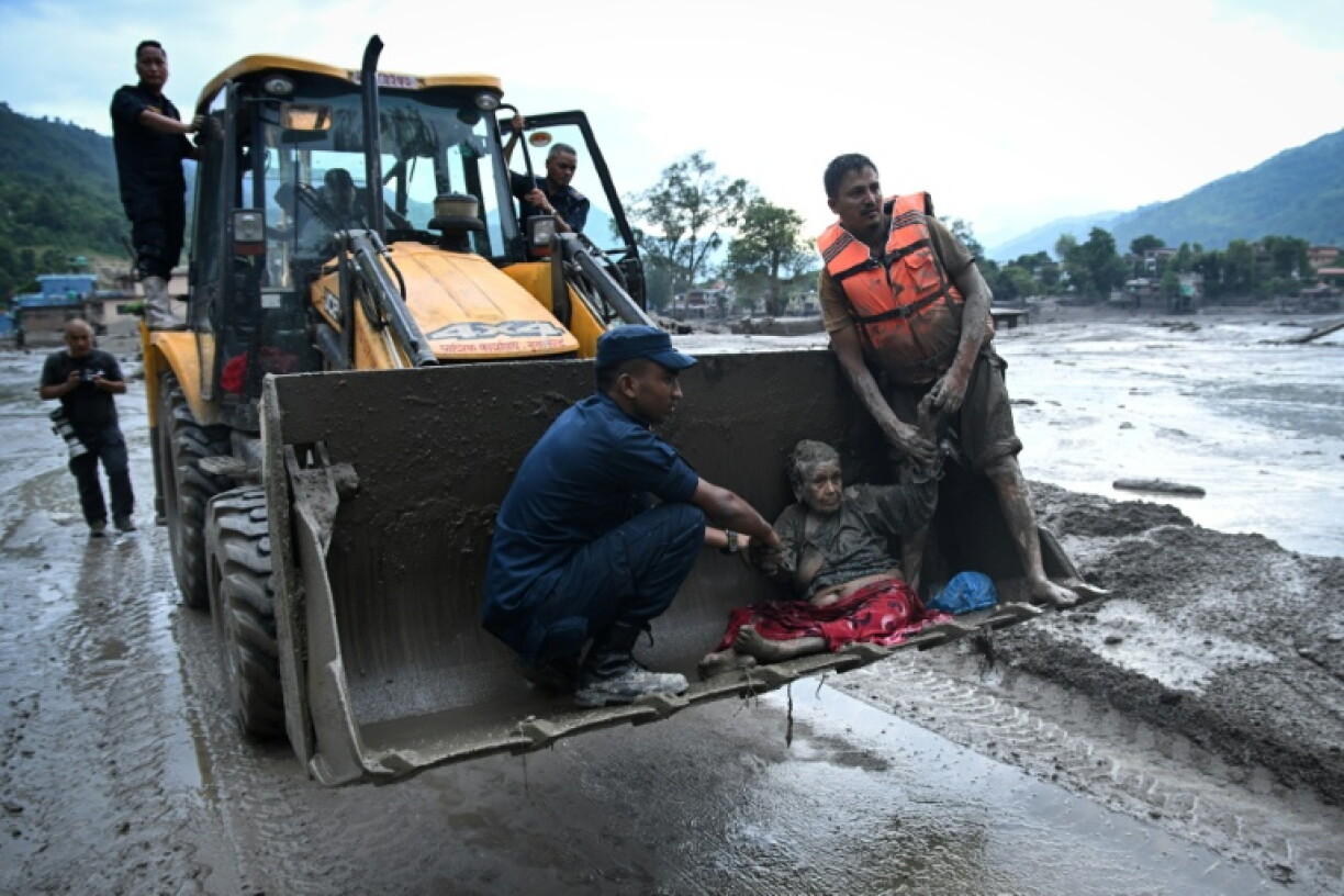 Les secouristes évacuent une personne ayant survécu à la crue soudaine à Devghat, dans le district de Nuwakot au Népal, le 26 août 2026