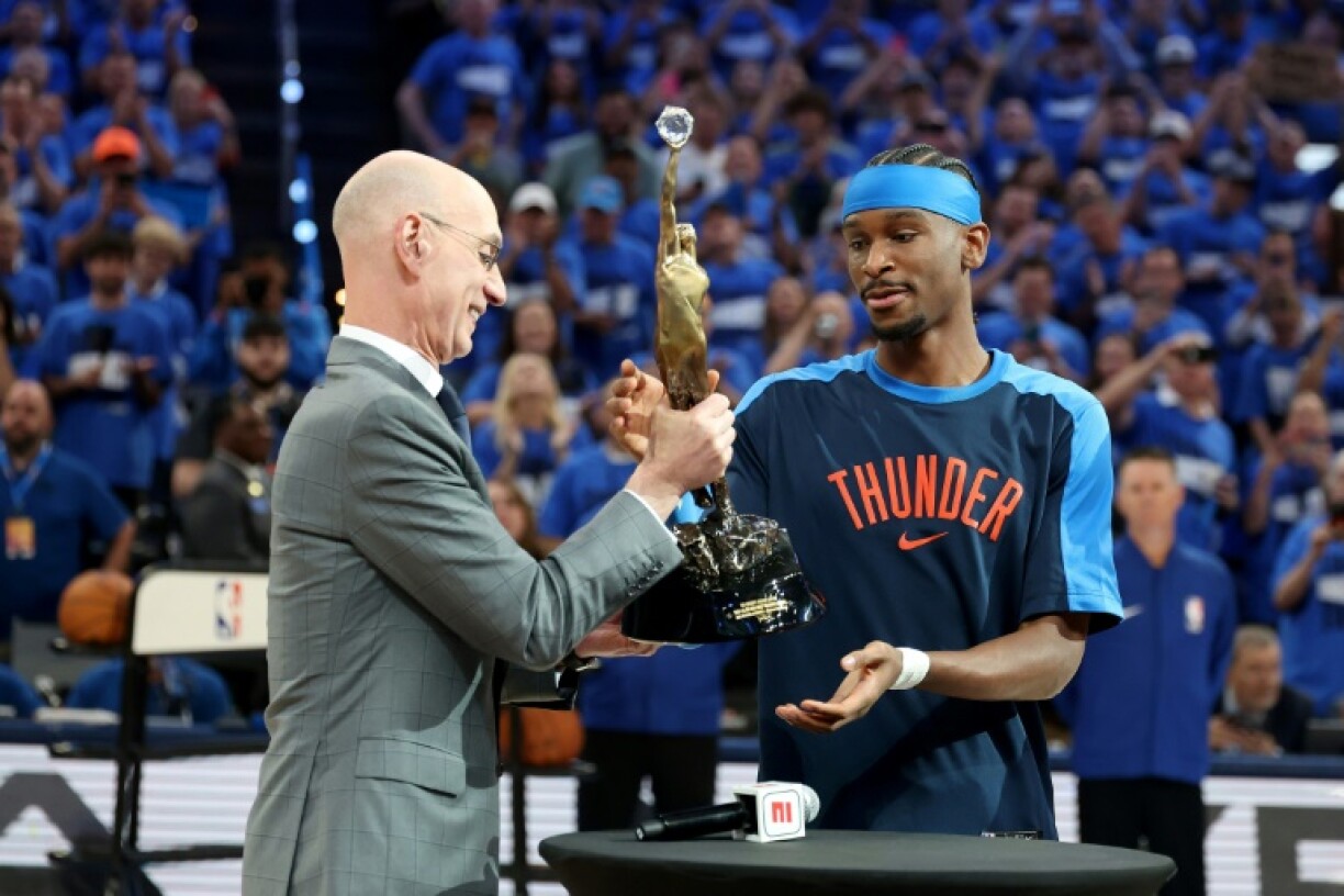 Commissioner of the NBA Adam Silver presents Shai Gilgeous-Alexander of the Oklahoma City Thunder with the MVP Michael Jordan Trophy.