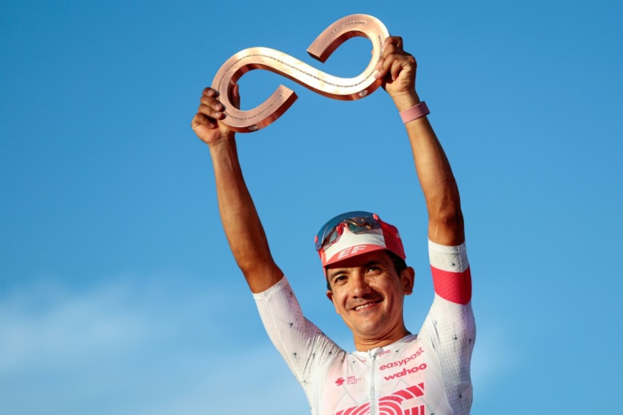 Richard Carapaz celebrating on the podium after finishing third in the Giro d'Italia