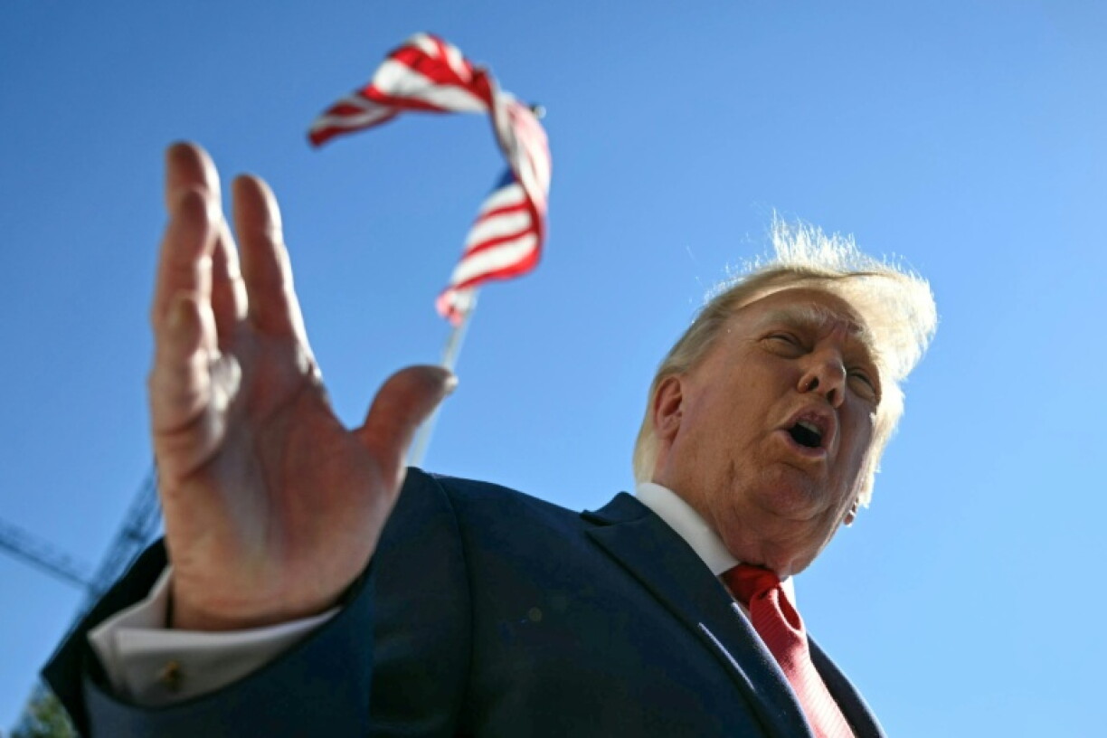 US President Donald Trump talks to members of the press before boarding Marine One from the South Lawn of the White House