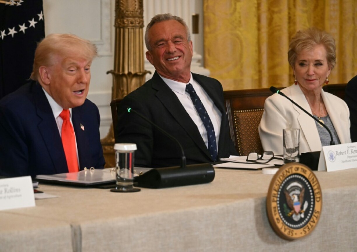 US President Donald Trump speaks as US Secretary of Health and Human Services Robert F. Kennedy Jr. (C), and US Secretary of Education Linda McMahon look on during a MAHA (Make America Healthy Again) Commission Event