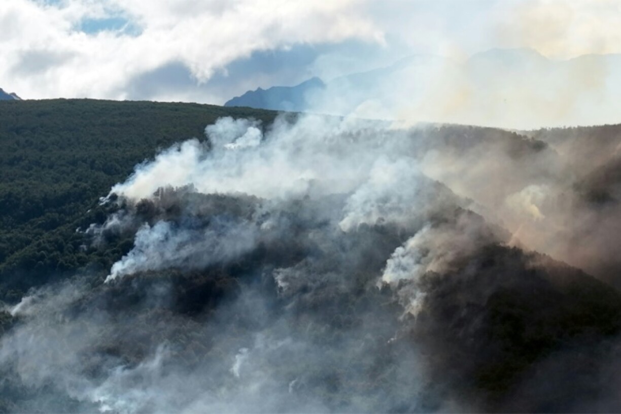 Smoke rises above the mountains near El Bolson, in the Patagonian province of Rio Negro, Argentina, on February 4, 2025