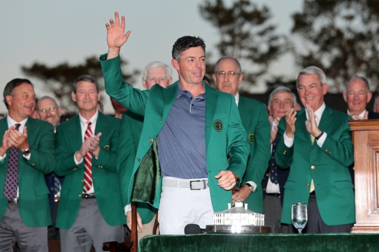 Rory McIlroy of Northern Ireland is congratulated after receiving the green jacket awarded to the winner of the Masters at Augusta National
