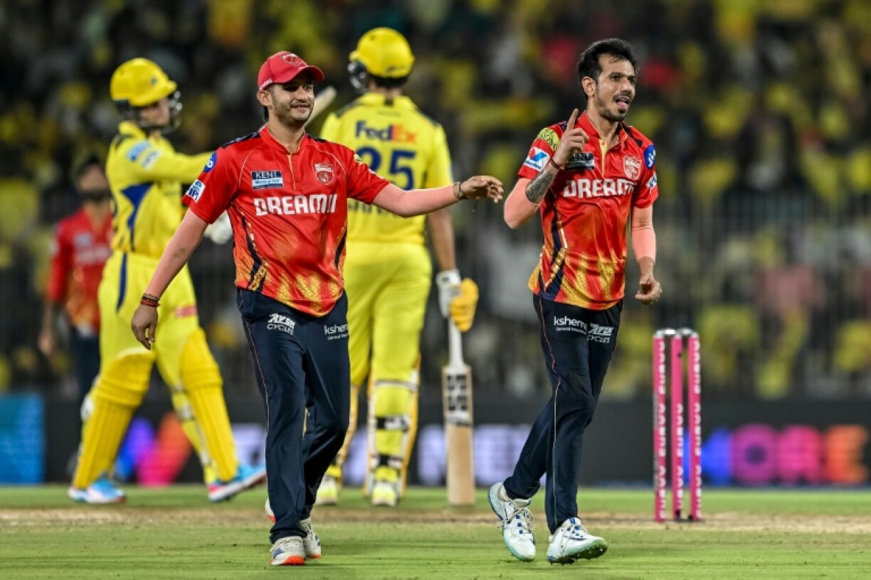 Punjab Kings' Yuzvendra Chahal (R) took the first hat-trick of the IPL season
