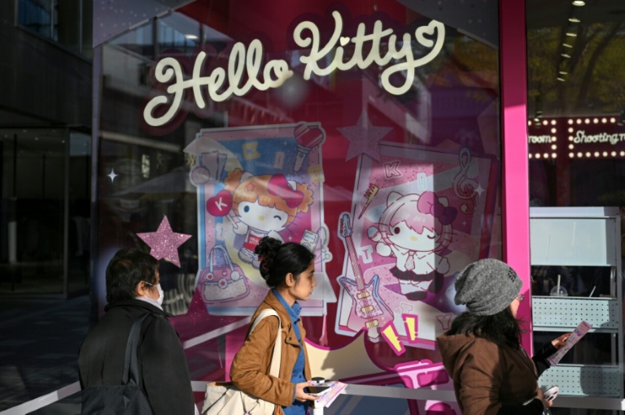 People queue to enter a Hello Kitty store at a shopping mall in Beijing on October 29