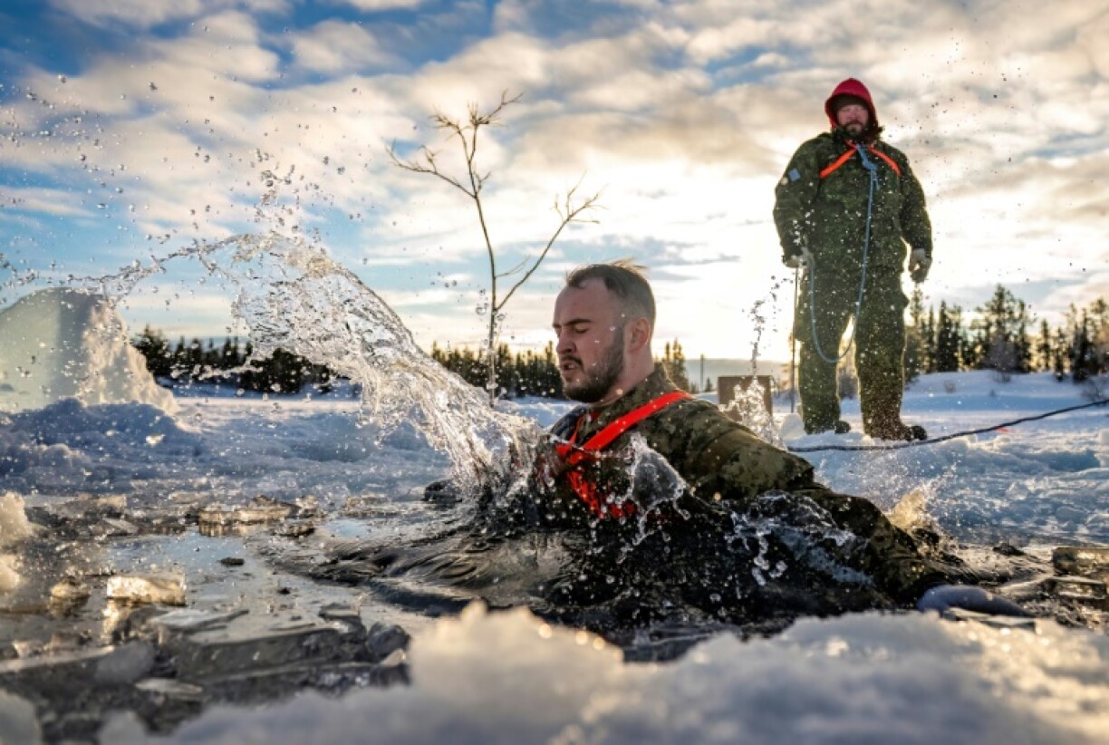 A soldier swims during a cold-water immersion exercise near the Joint Task Force North's headquarters in Yellowknife in January 2025