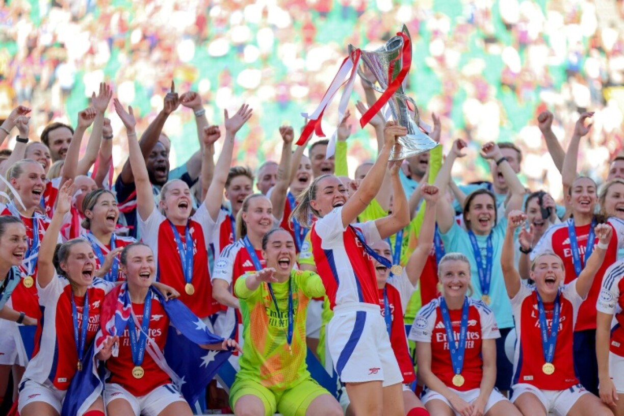 Arsenal's players celebrate with the trophy after winning the UEFA Women's Champions League against Barcelona