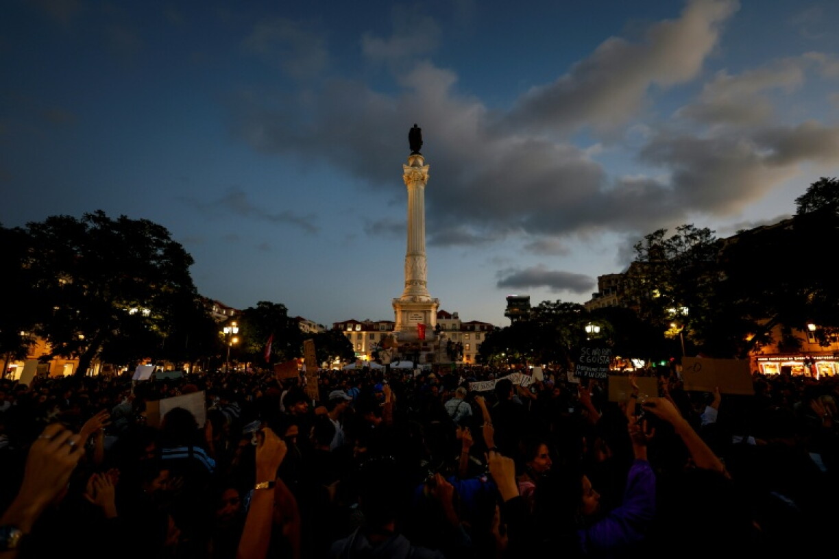 Hundreds of protesters rallied at night in Rossio square -- located at the bustling, touristic heart of the Portuguese capital