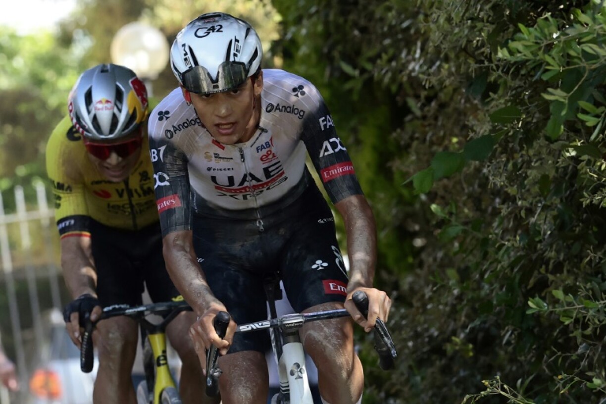 Isaac del Toro rides in front of Wout van Aert after the pair broke away from the rest of the field