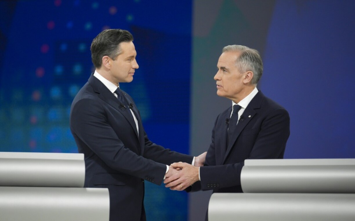 Conservative Leader Pierre Poilievre and Canadian Prime Minister and Liberal Party chief Mark Carney shake hands following an election debate in Montreal on April 17