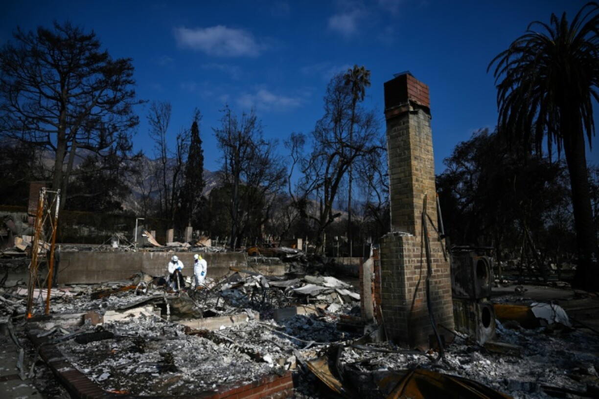 US Environmental Protection Agency contractors remove hazardous waste as they search homes damaged and destroyed by the Eaton Fire in California