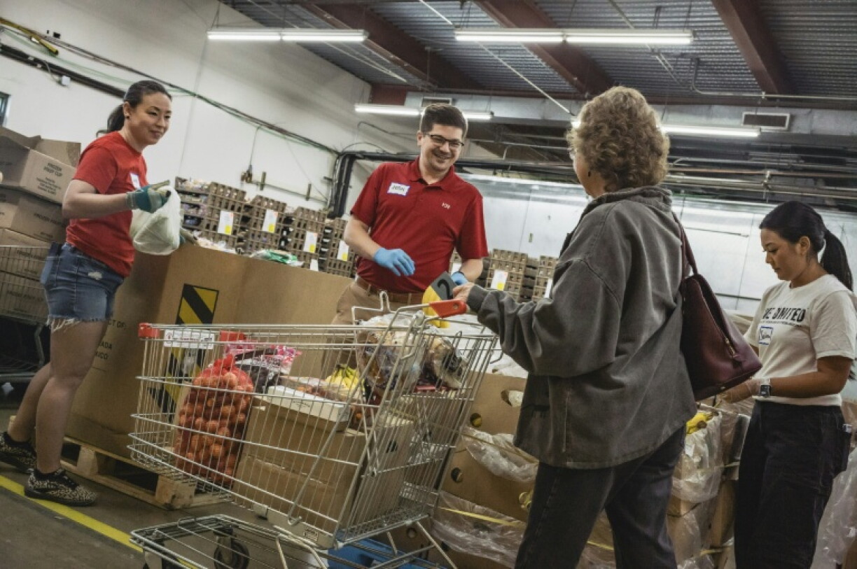 Food bank volunteers help fill the carts of those in need in Tuscon, Arizona