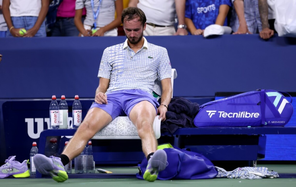A dejected Daniil Medvedev sits on his chair after crashing out of the US Open first round following the latest in a long line of on-court meltdowns