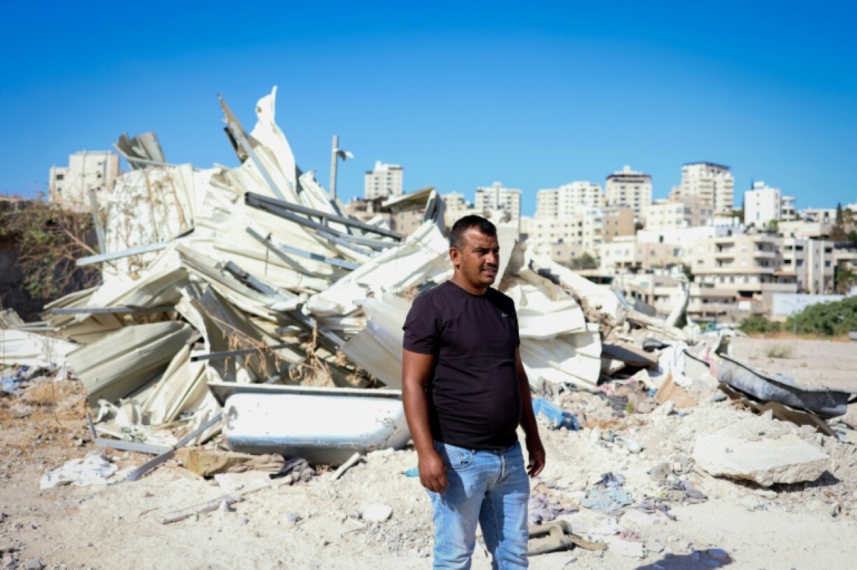 Yahya Abu Ghaliyeh stands in front of his demolished house near the town of Al-Eizariya, also known as Bethany