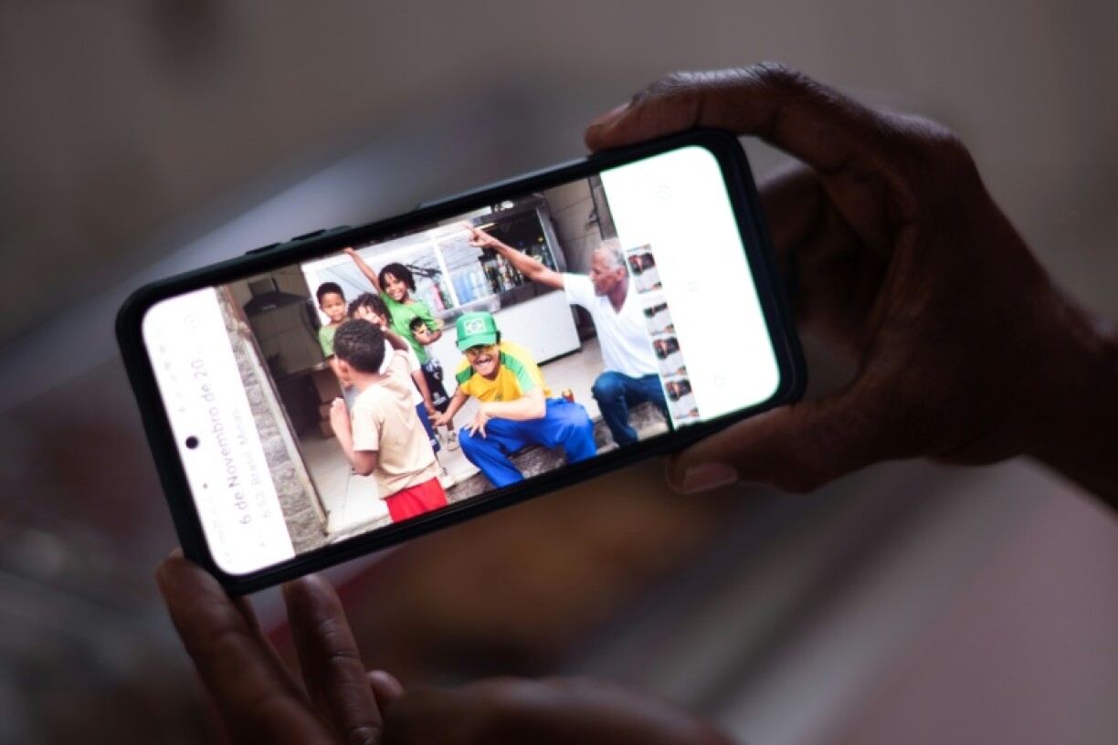 Ronaldo Teixeira, owner of the Lacador bar, watches the video made with Bruno Mars at his establishment in Belo Horizonte, Brazil