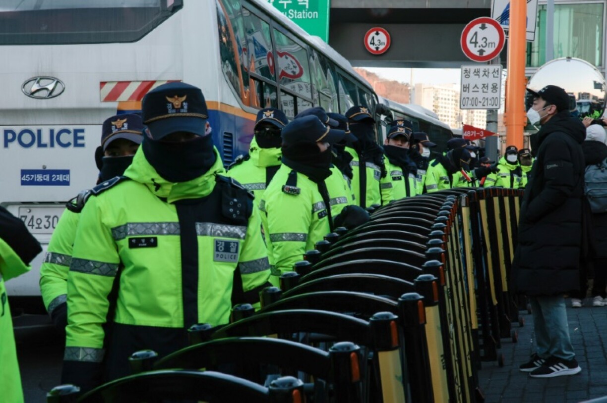 Police officers patrol near the residence of impeached South Korean President Yoon Suk Yeol