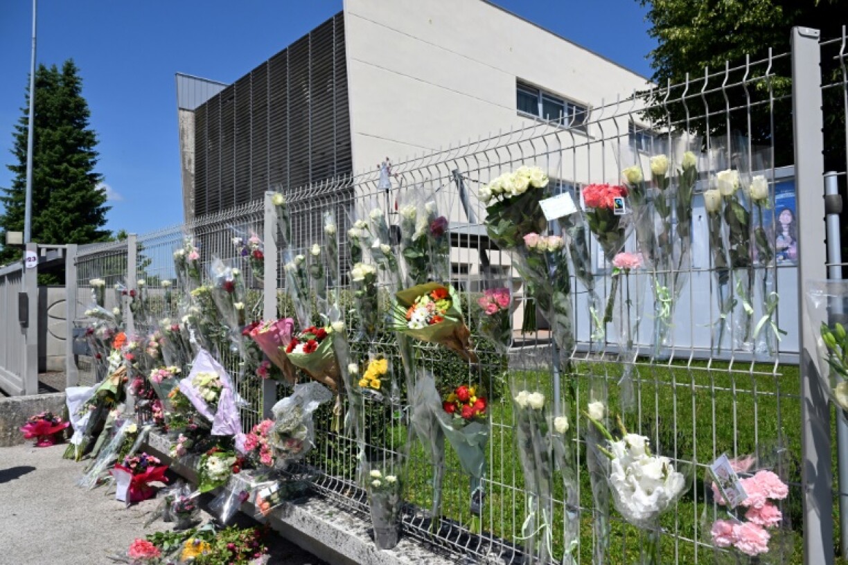 Friends and well-wishers left flowers and messages of support in front of the secondary school in the eastern town of Nogent