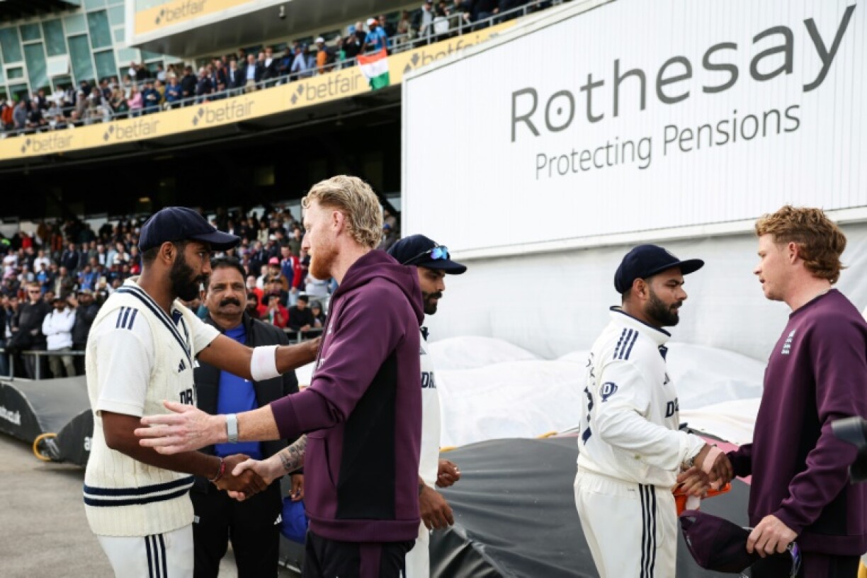 England captain Ben Stokes (2nd L) shakes hands with India's Jasprit Bumrah (L) after England's five-wicket win in the first Test at Headingley
