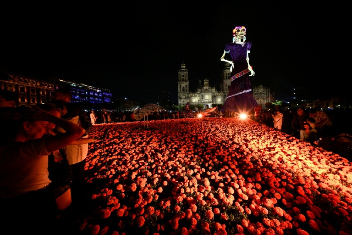 An 11-story Catrina -- an elegantly dressed female skeleton -- stands in the Zocalo, the capital's main square, as part of this year's festivities