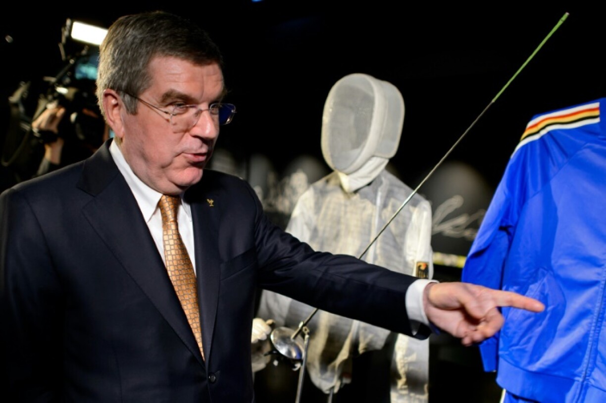 Thomas Bach, posing beside the fencing outfit he wore when he won 1976 Olympic team gold, faced huge challenges in his 12-year tenure as IOC president