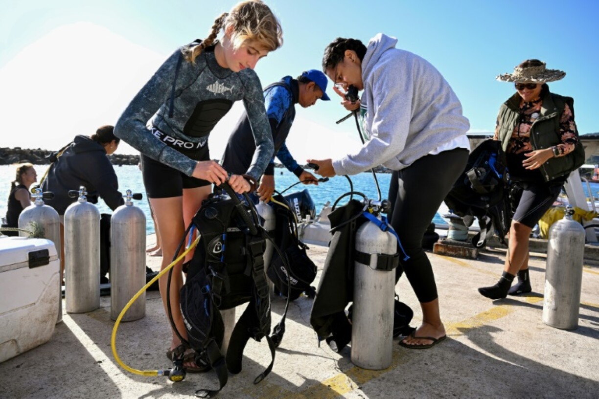 Divers from the environmental group Korero O Te Orau preparing their gear before collecting crown-of-thorns starfish from a reef off Rarotonga in the Cook Islands