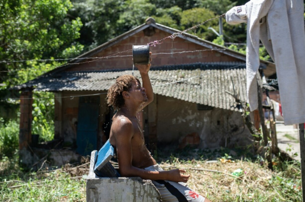 A man cools off by taking bucket baths in the Guaratiba neighborhood of Rio de Janeiro, which hit 44 degrees Celcius, a record in the city