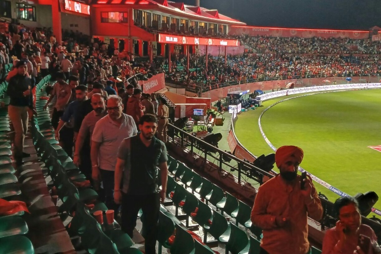 Spectators leave the ground after the IPL match between Punjab Kings and Delhi Capitals was abandoned