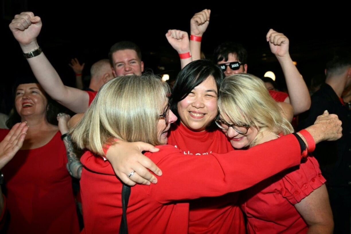 Labor Party supporters react as national broadcaster ABC projects a win for the party in Australia's general election